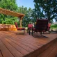 deck with some red chairs and trees around